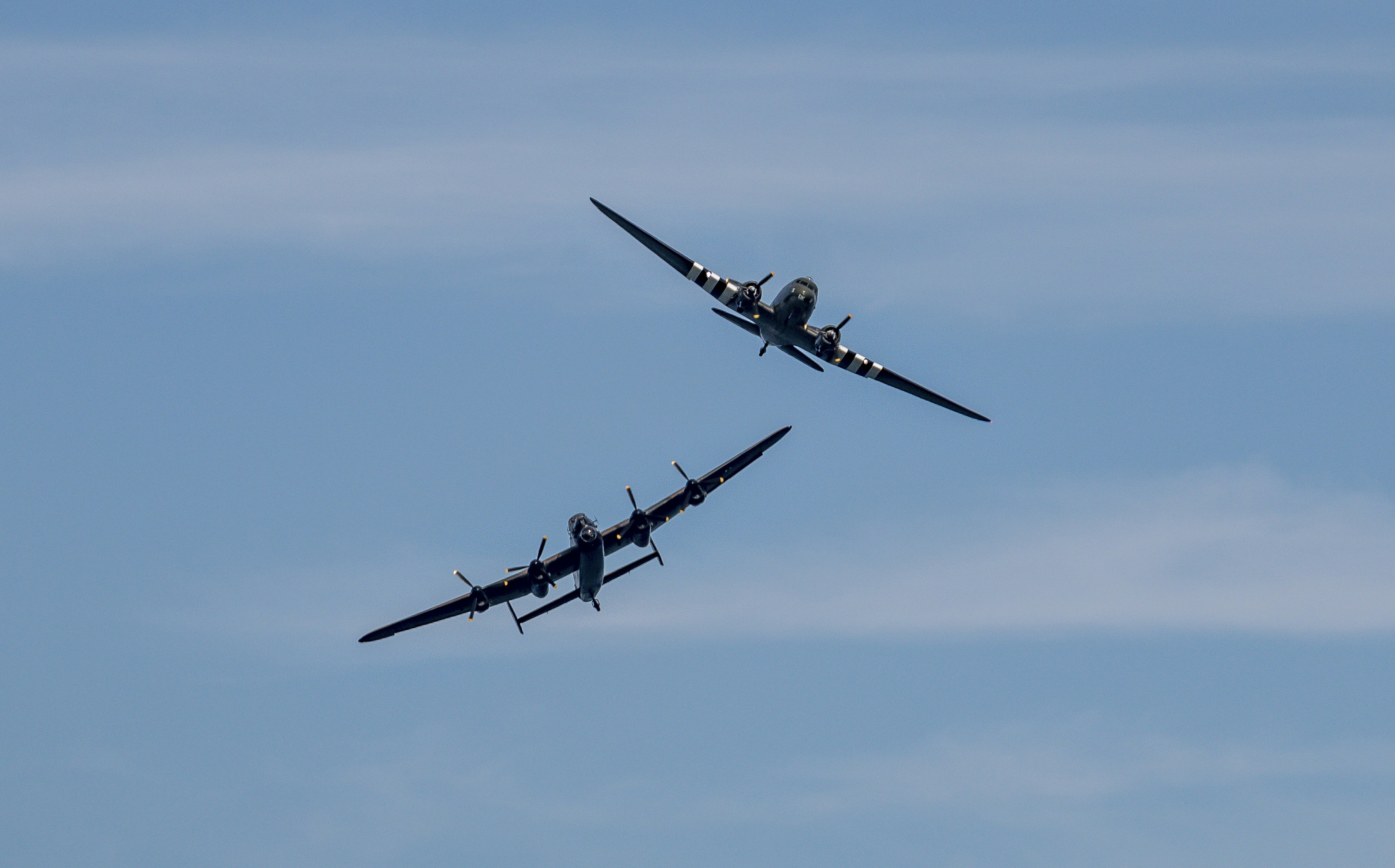 black airplane in mid air during daytime