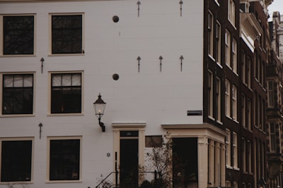Exterior view of Engels Paint Specialists store on Van Hallstraat with parked cars.