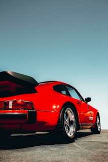 A vibrant red sports car gleaming under the clear sky, ready for a thrilling ride through Chhattisgarh.
