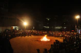 A community gathering outdoors, people sharing stories in a circle.
