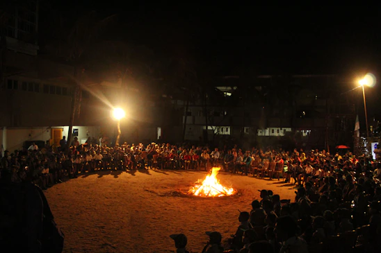 A group of diverse community members sharing stories together around a warm fire, symbolizing connection and cultural preservation.