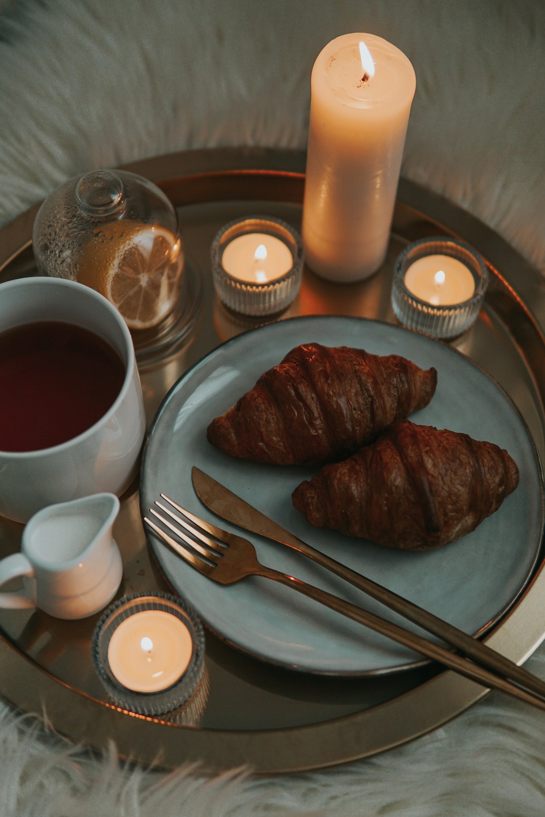 sliced meat on white ceramic plate beside stainless steel fork and knife