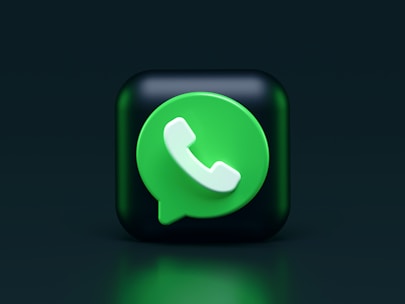 A 3D representation of a green chat bubble with a white phone icon inside, placed on a dark green background. The icon is similar to a well-known messaging app symbol.