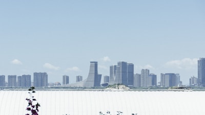 Modern Riyadh skyline with gleaming skyscrapers against a clear blue sky.