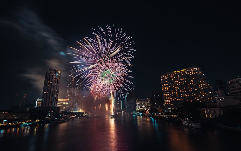 fireworks display over high rise buildings during night time