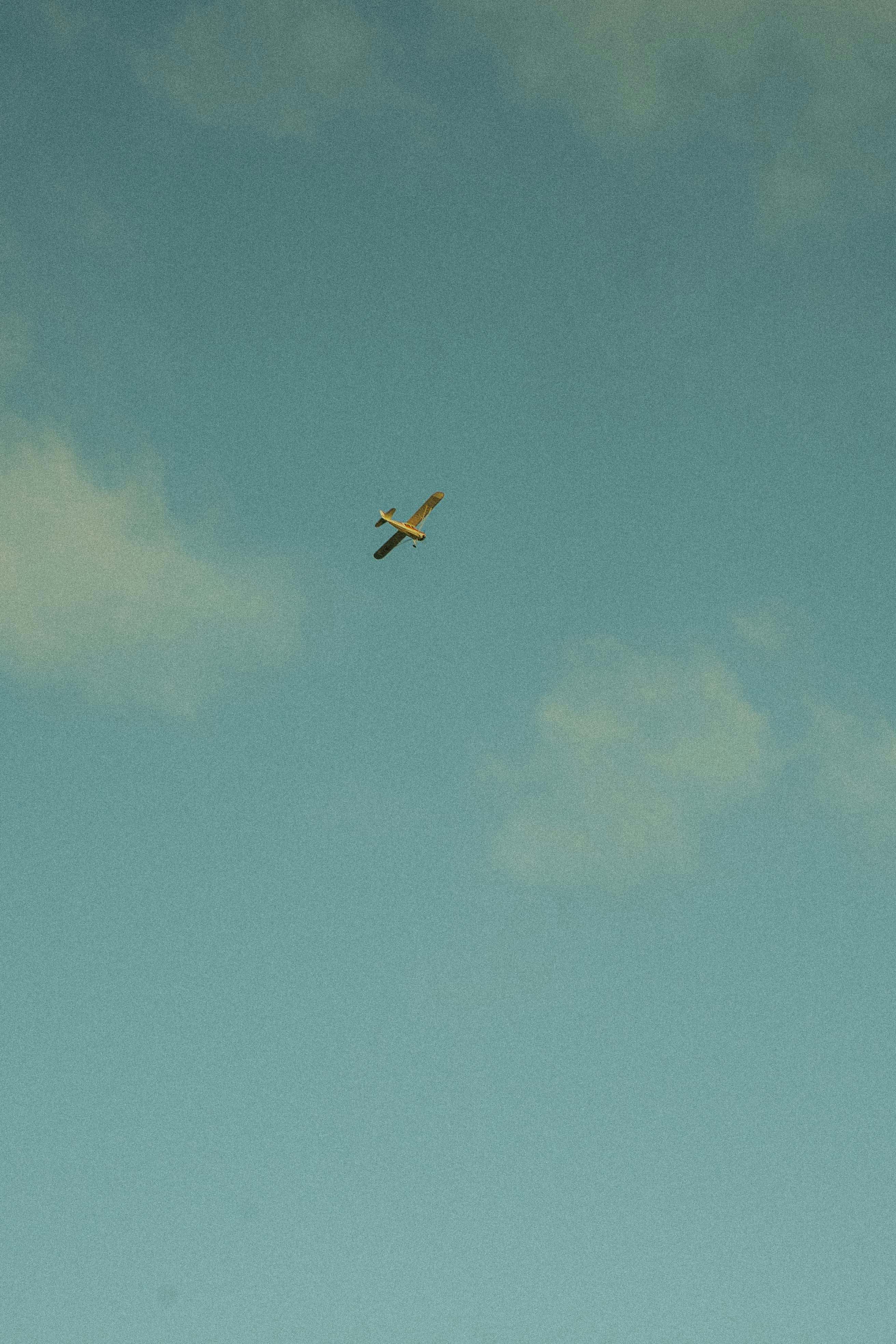 white and black airplane in mid air during daytime