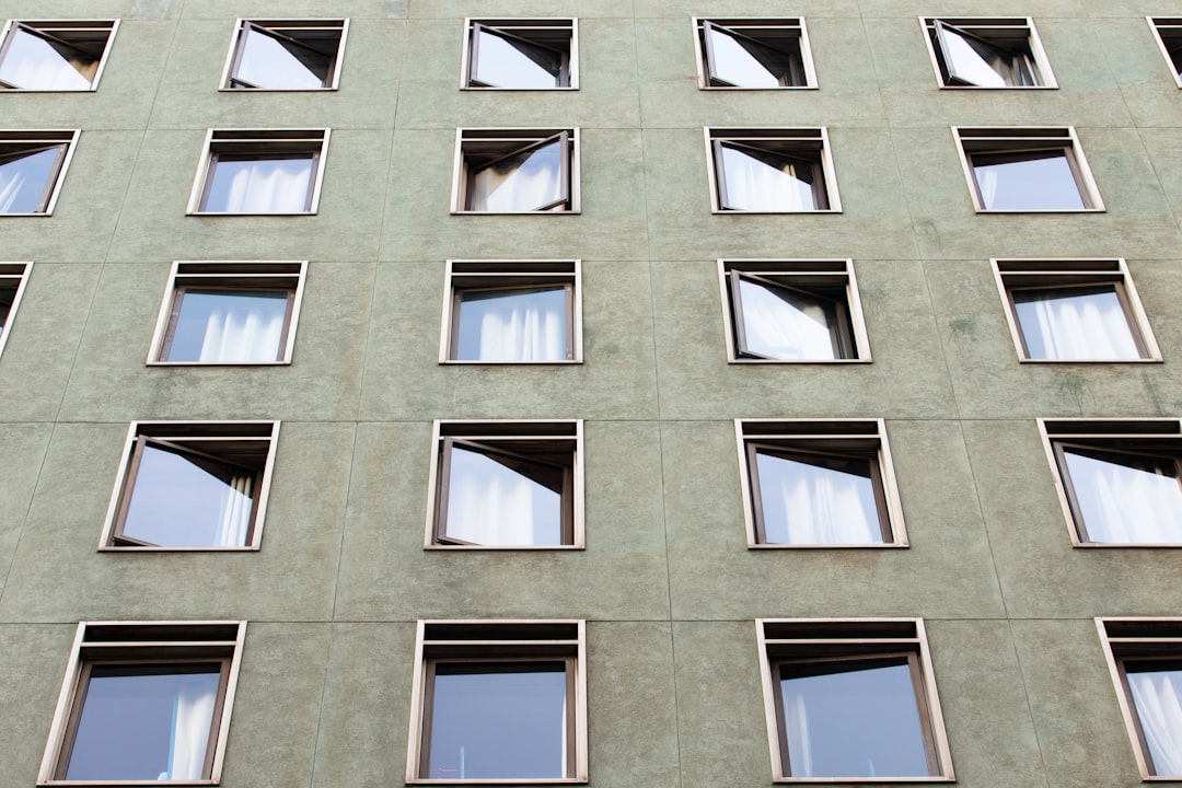 brown concrete building with glass windows