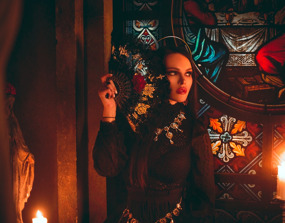 woman in black and brown long sleeve dress standing beside brown wooden door