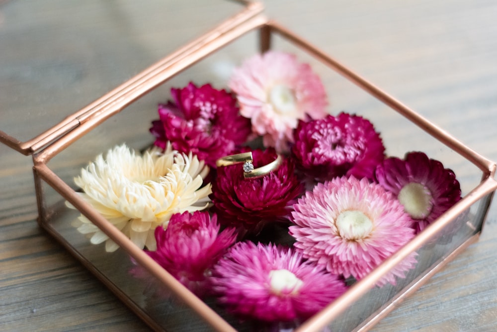 pink and yellow flowers in brown box