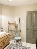 white wooden door beside white ceramic sink