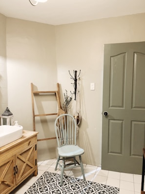 white wooden door beside white ceramic sink