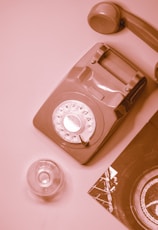 white rotary phone on white table