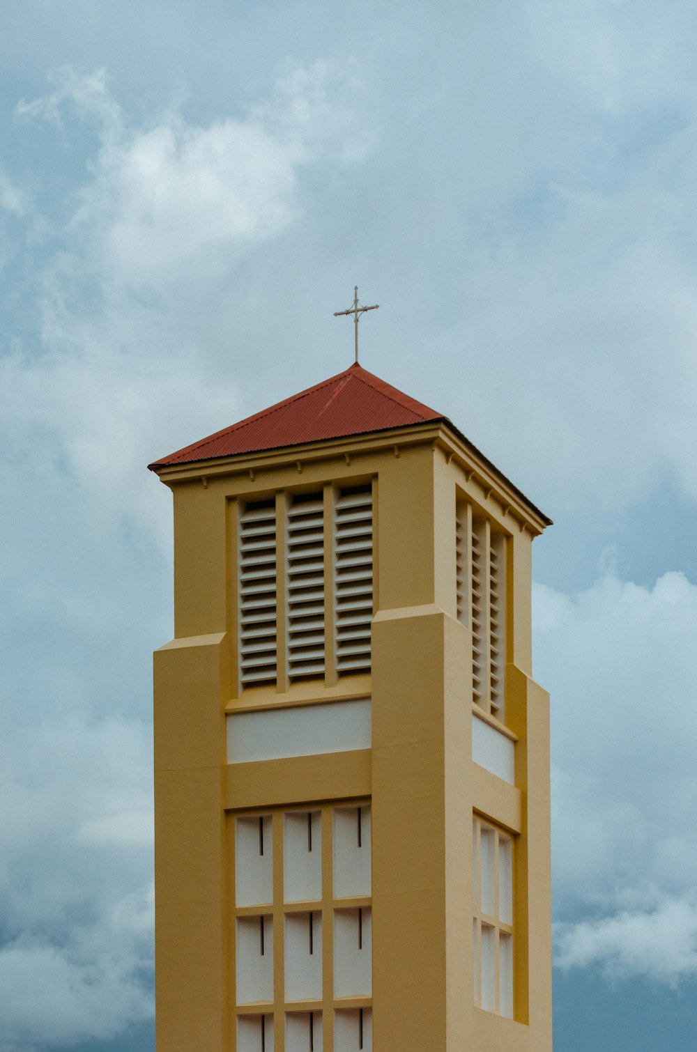 beige and brown concrete building under white clouds during daytime