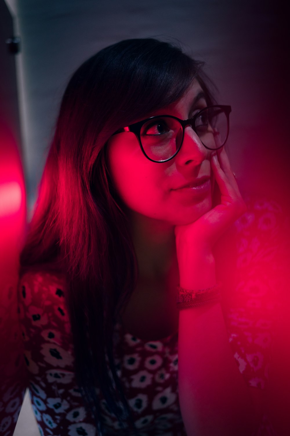 woman in black and white polka dot shirt wearing black framed eyeglasses