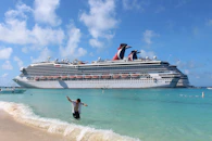 woman in black dress jumping on water during daytime
