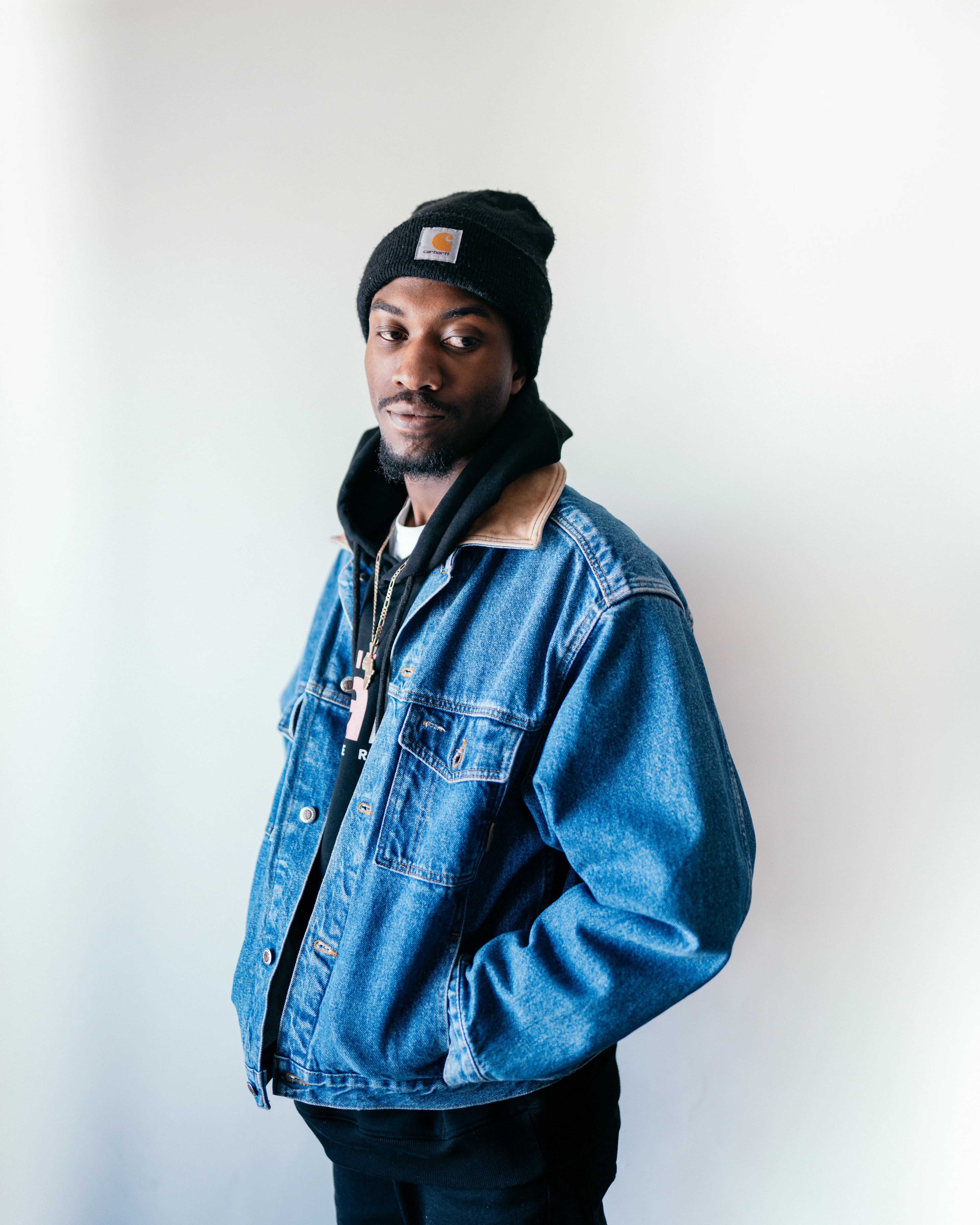 Man in a sherpa-lined denim jacket and black beanie