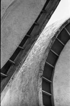 Abstract architectural detail showing interplay of shadows on raw concrete surfaces.