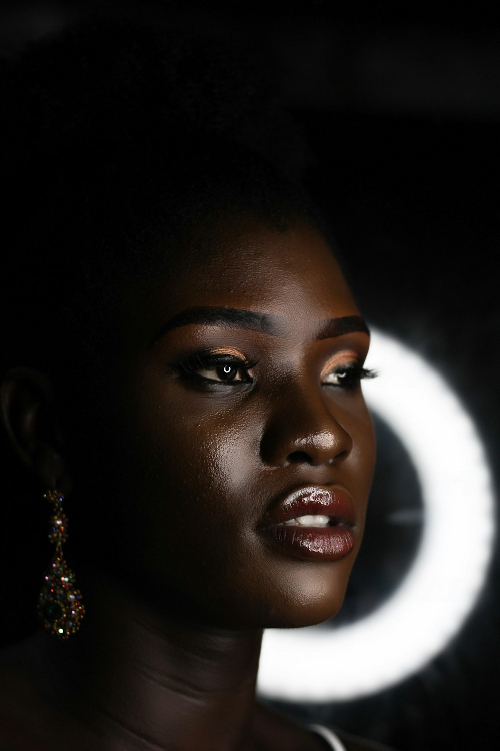 woman wearing silver and gold earrings