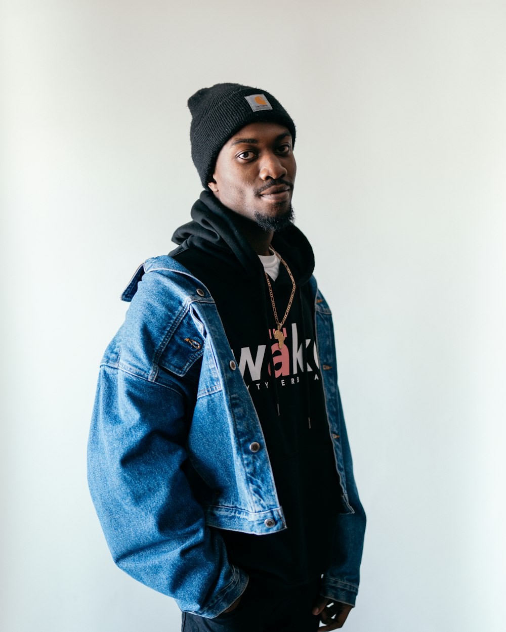 man in blue denim jacket and black knit cap