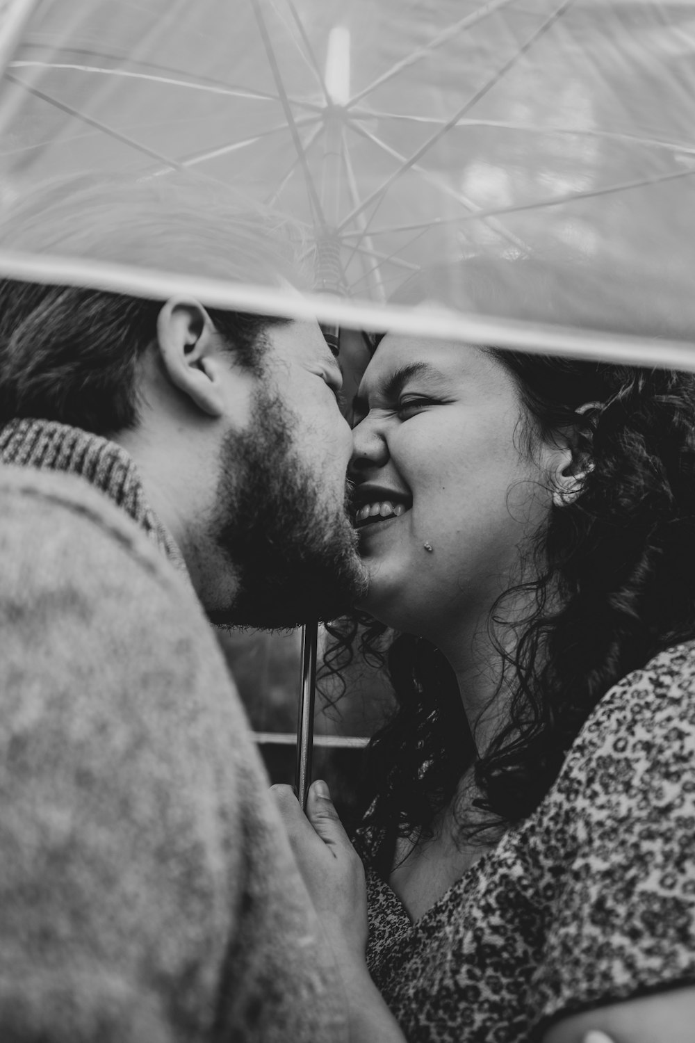 grayscale photo of man and woman kissing