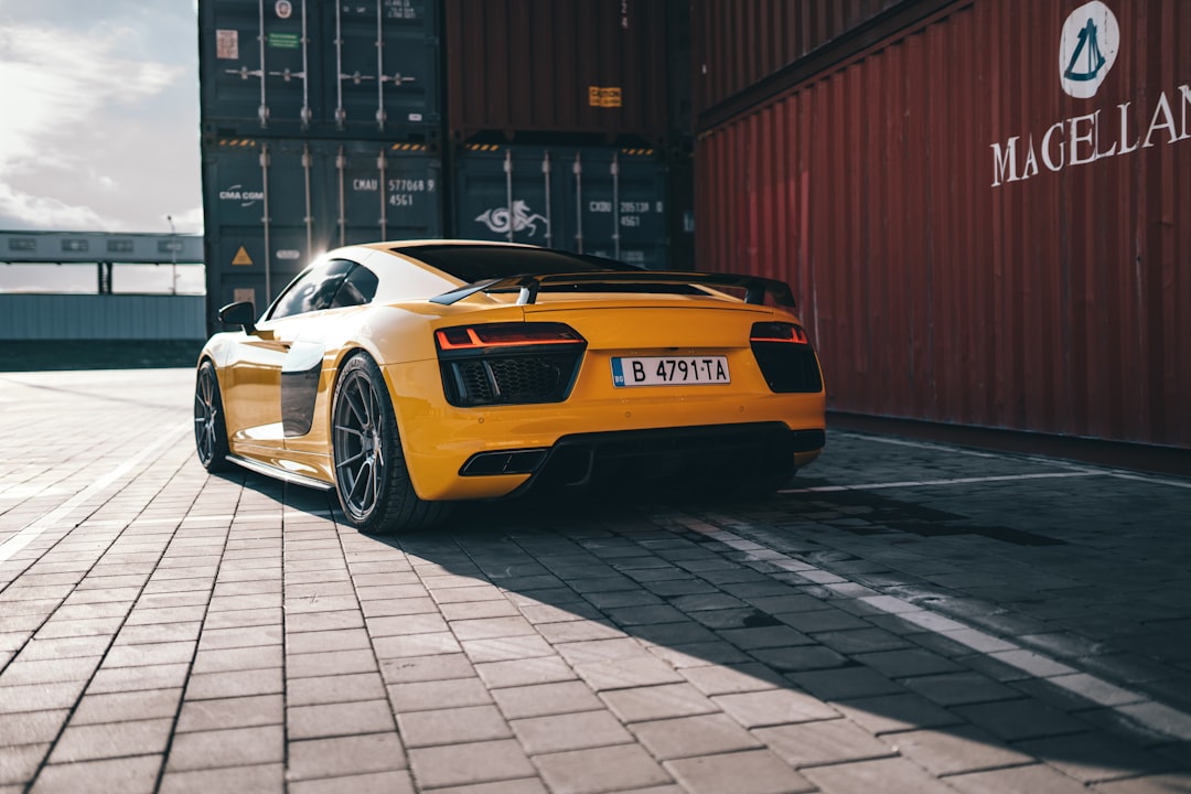 yellow porsche 911 parked on sidewalk during daytime