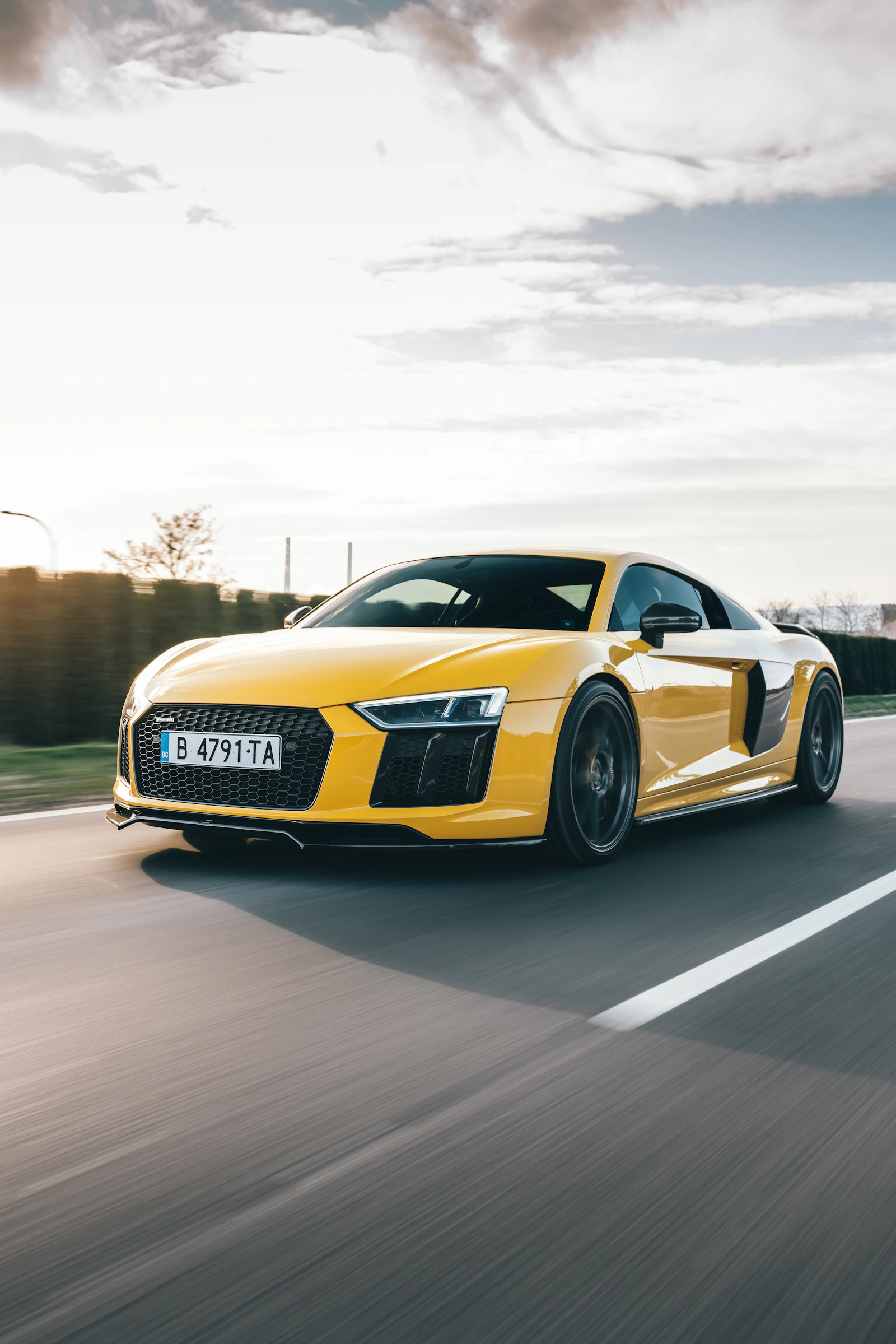 Gele Audi R8 rijdend op de weg