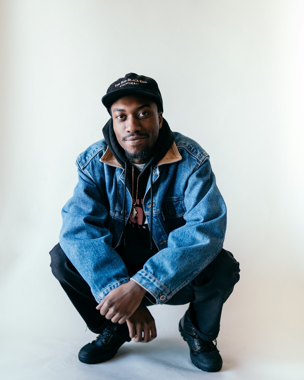 man in blue denim jacket and black knit cap