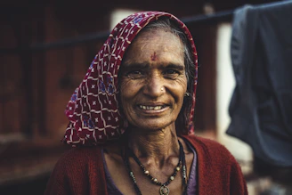 Portrait of Ratna, the founder of Eka Saara, smiling warmly in a softly lit boutique setting.