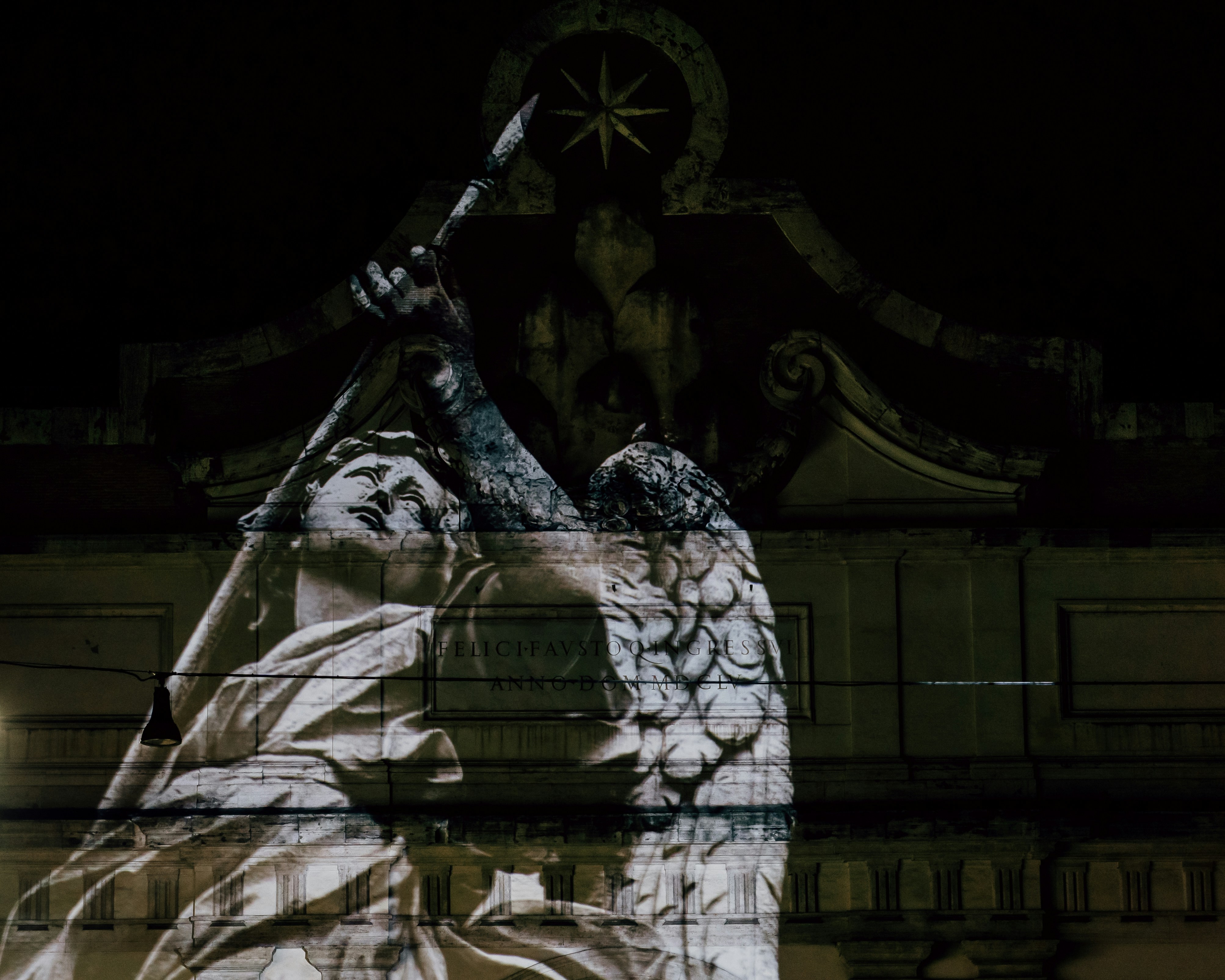 Angels projected onto the Porta del Popolo in Piazza del Popolo, Rome, Italy