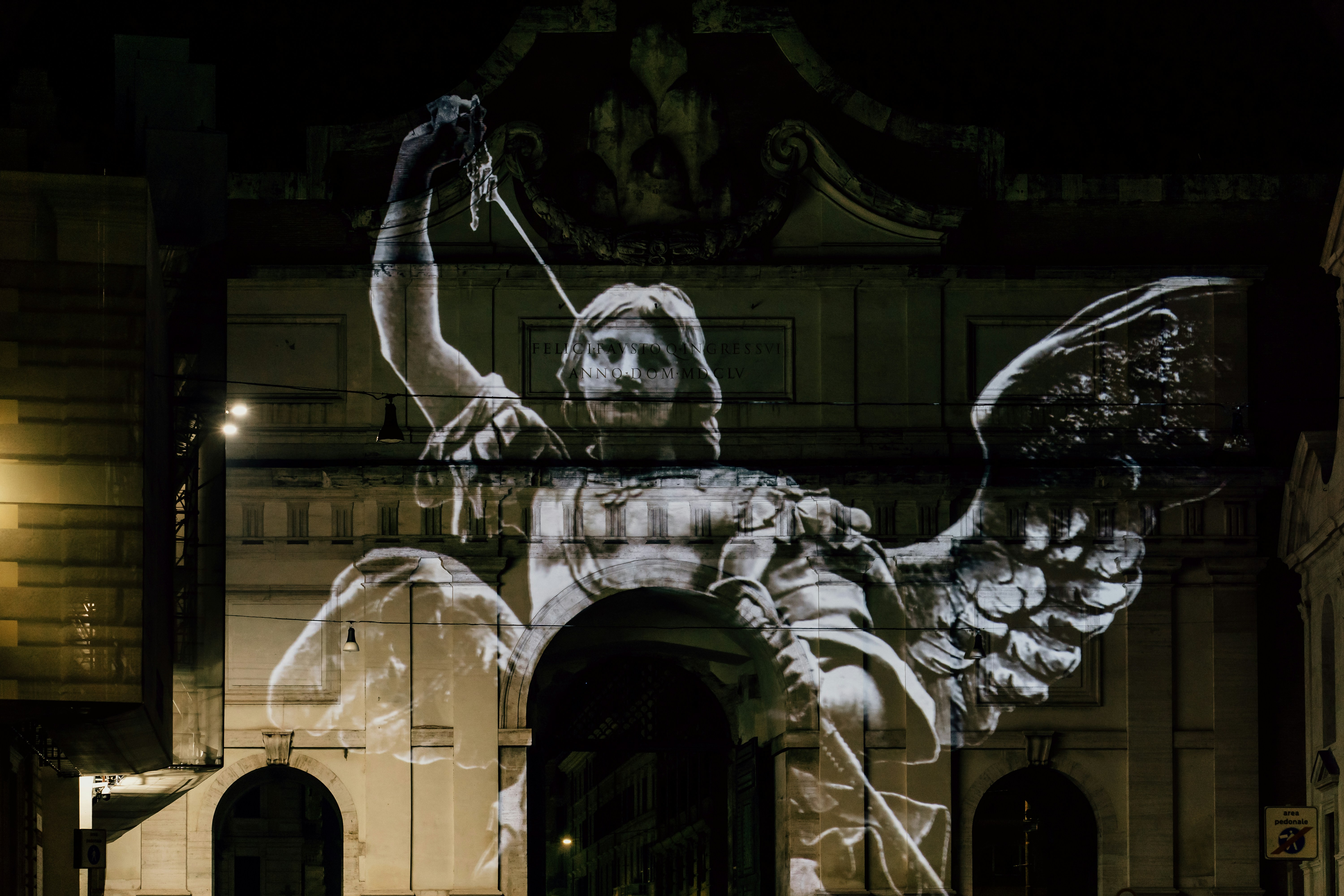 Angels projected onto the Porta del Popolo in Piazza del Popolo, Rome, Italy