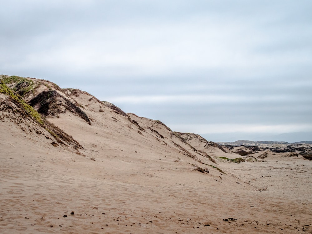 brown sand under white sky during daytime