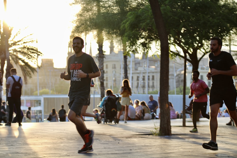 man in black crew neck t-shirt and gray shorts running on street during daytime