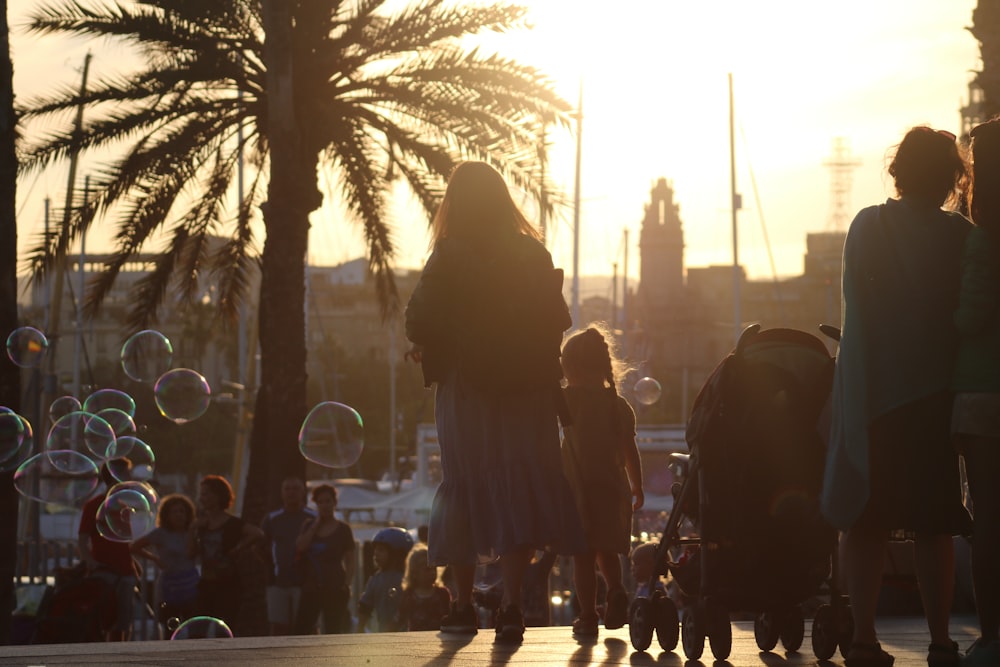 silhouette of people walking on street during night time