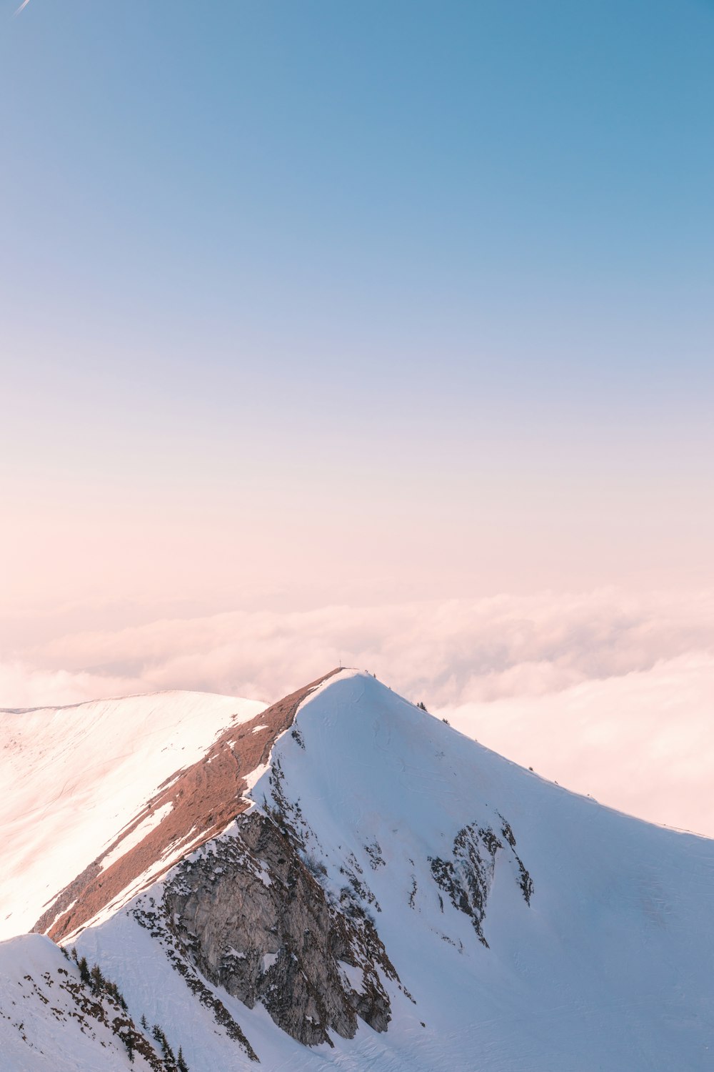 snow covered mountain under blue sky during daytime