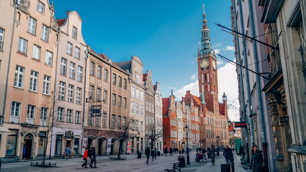 people walking on street near brown concrete building during daytime