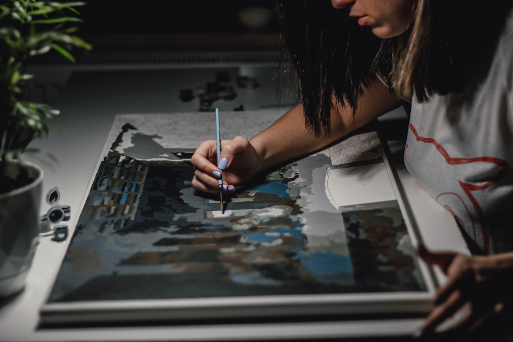 woman painting on white paper