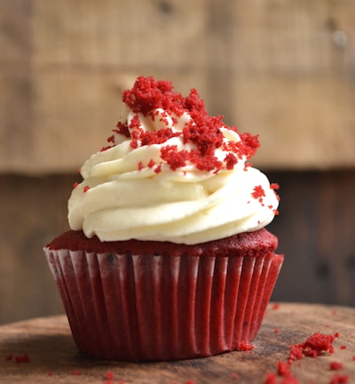 white and red cupcake with white icing on top