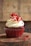 white and red cupcake with white icing on top