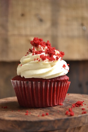 white and red cupcake with white icing on top