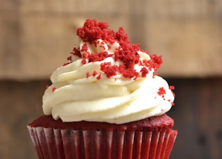 white and red cupcake with white icing on top