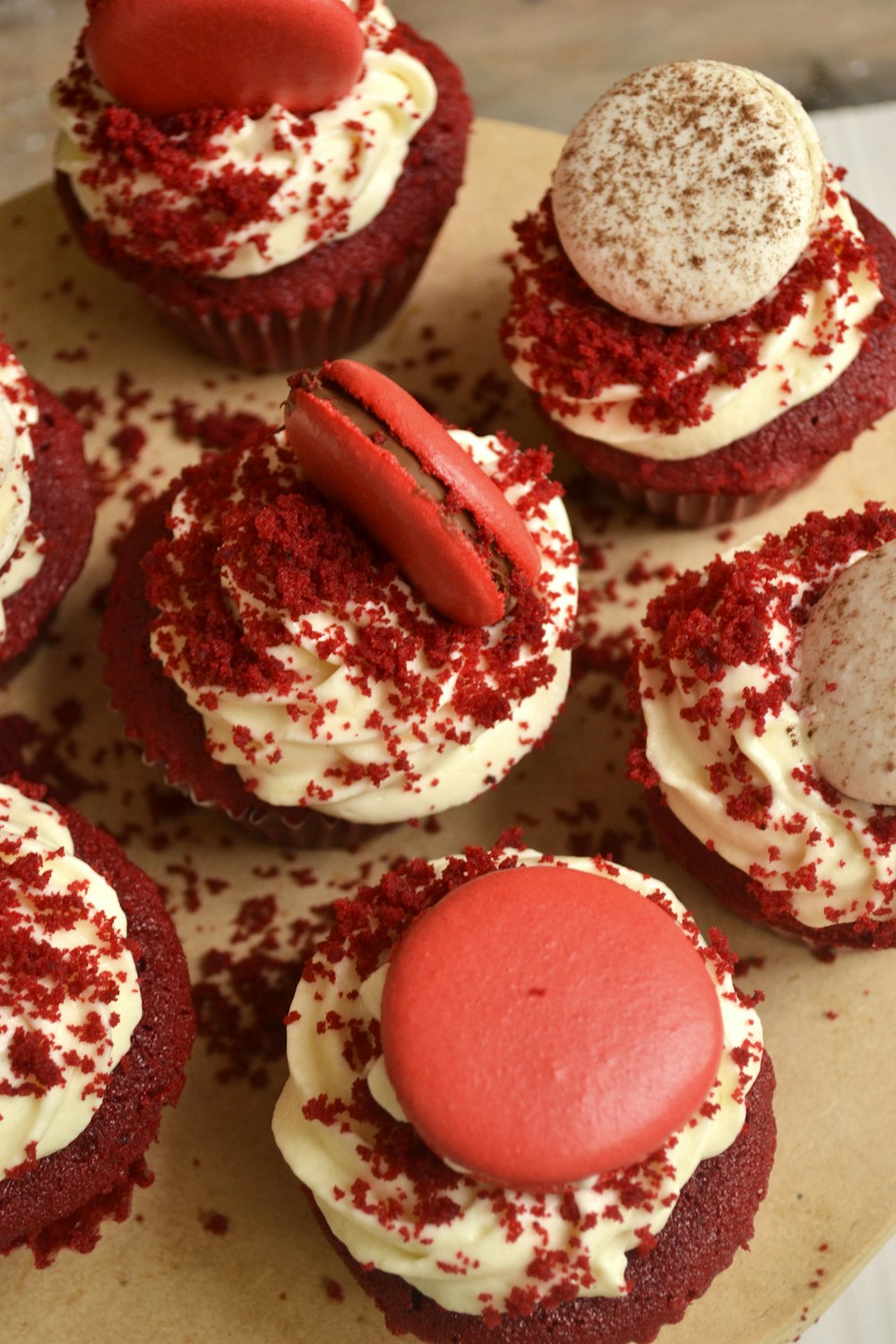 white and red cupcakes on brown wooden table