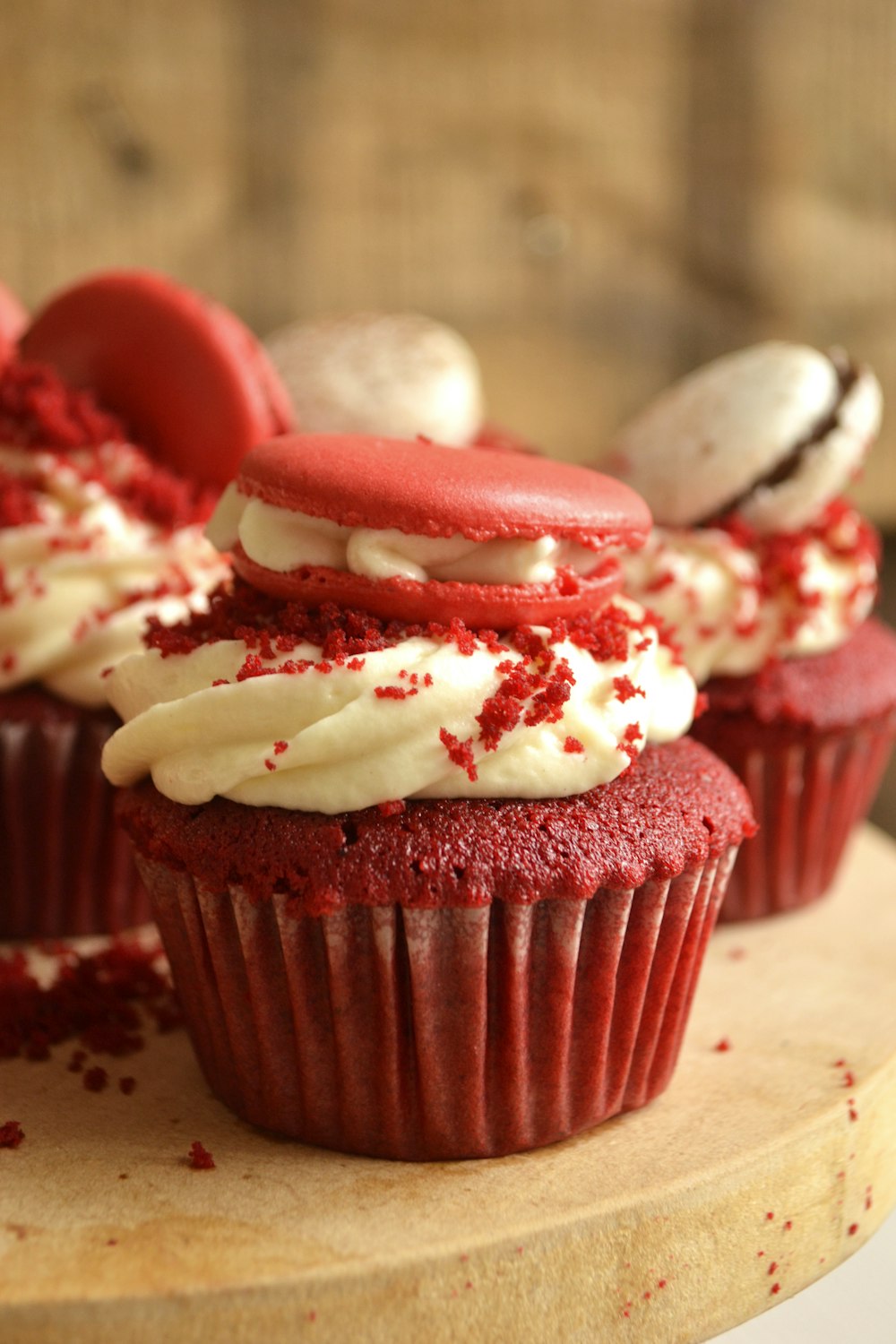 chocolate cupcake with white icing and strawberry on top