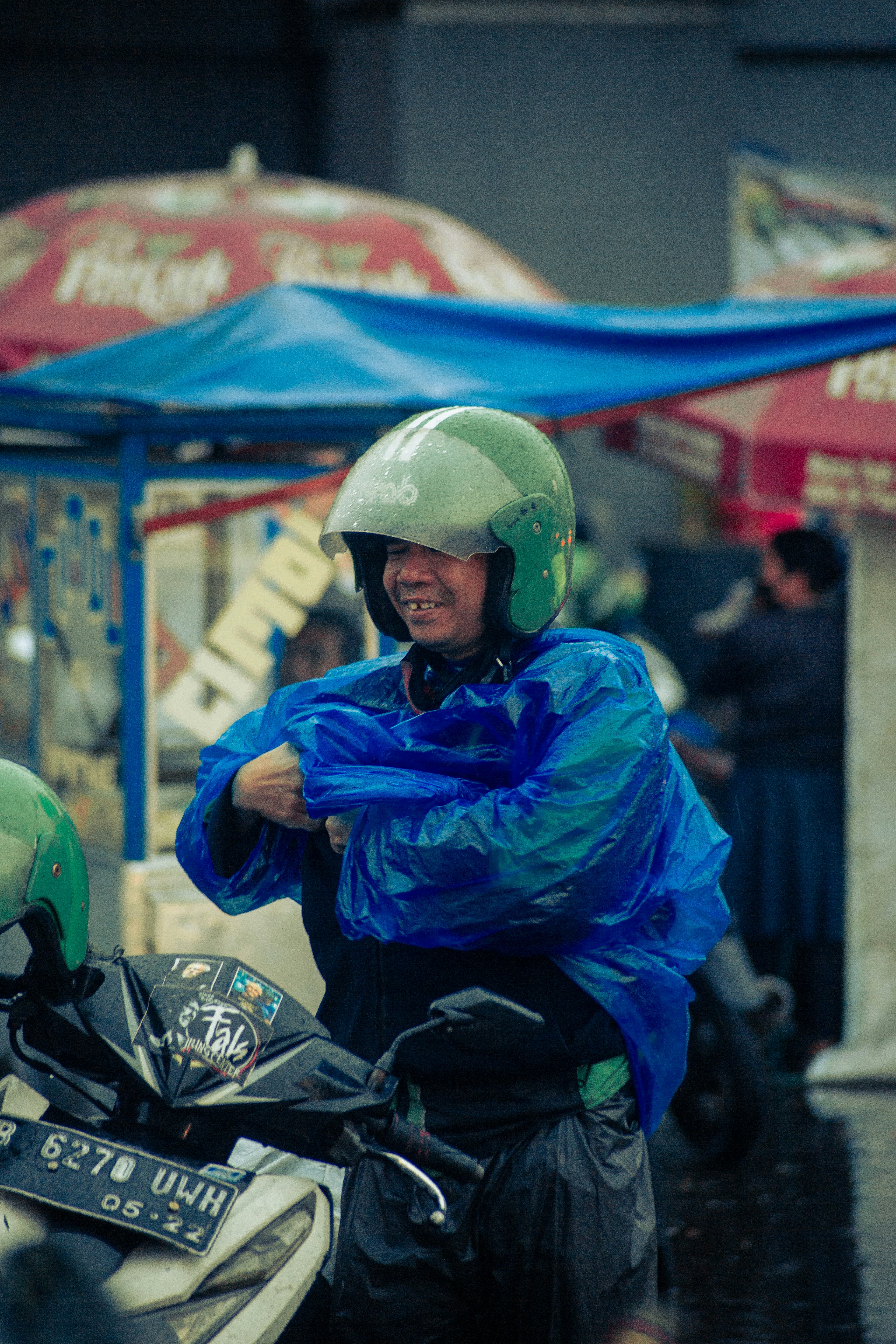 man in blue jacket riding motorcycle