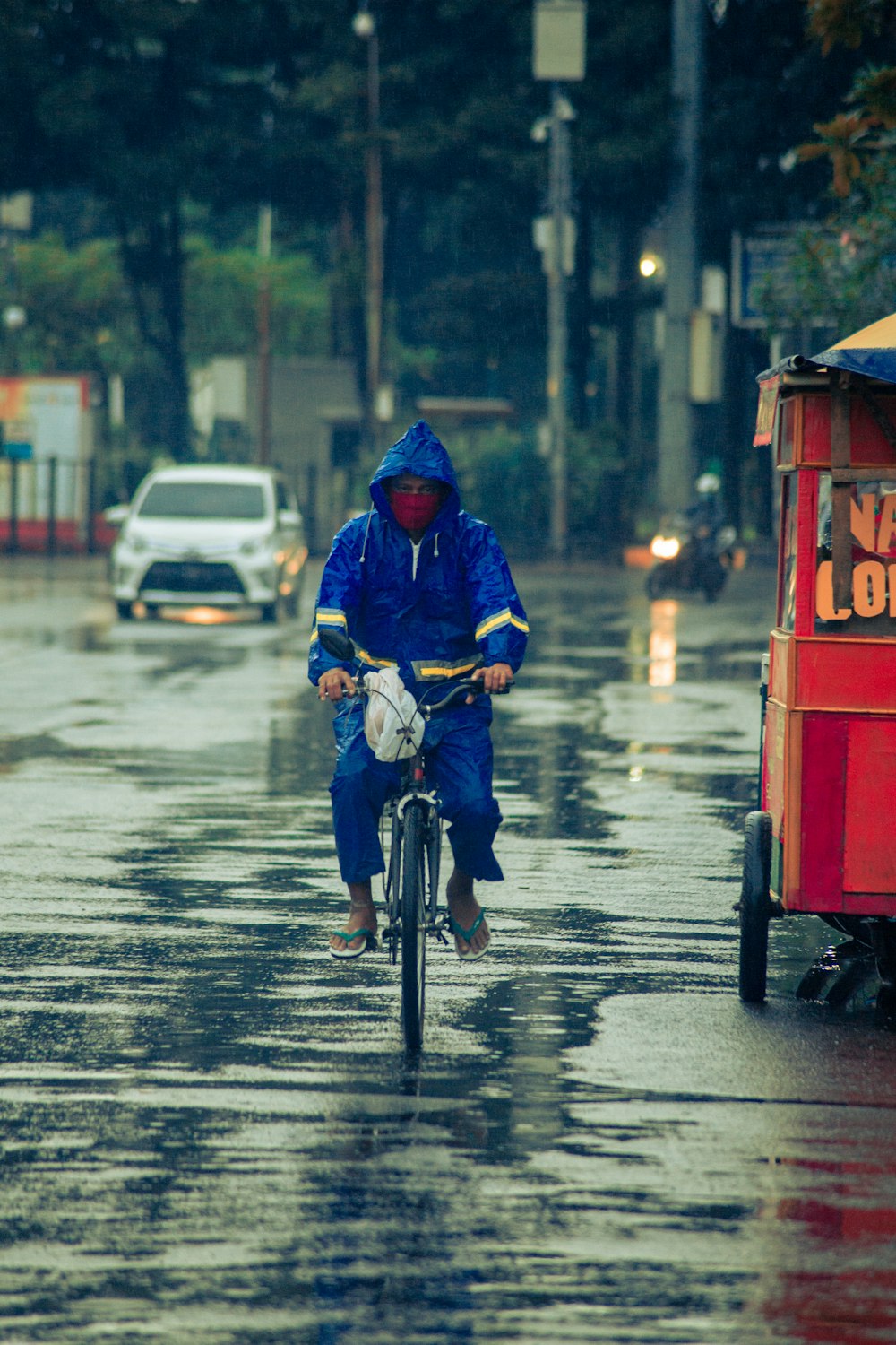 man in blue jacket riding motorcycle on road during daytime