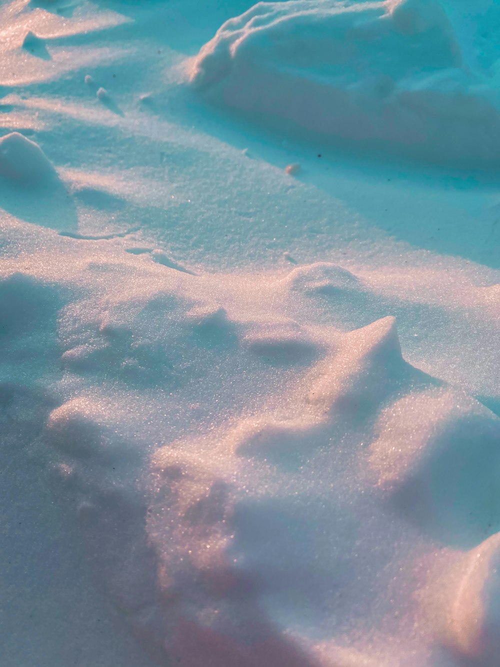 white sand on blue body of water