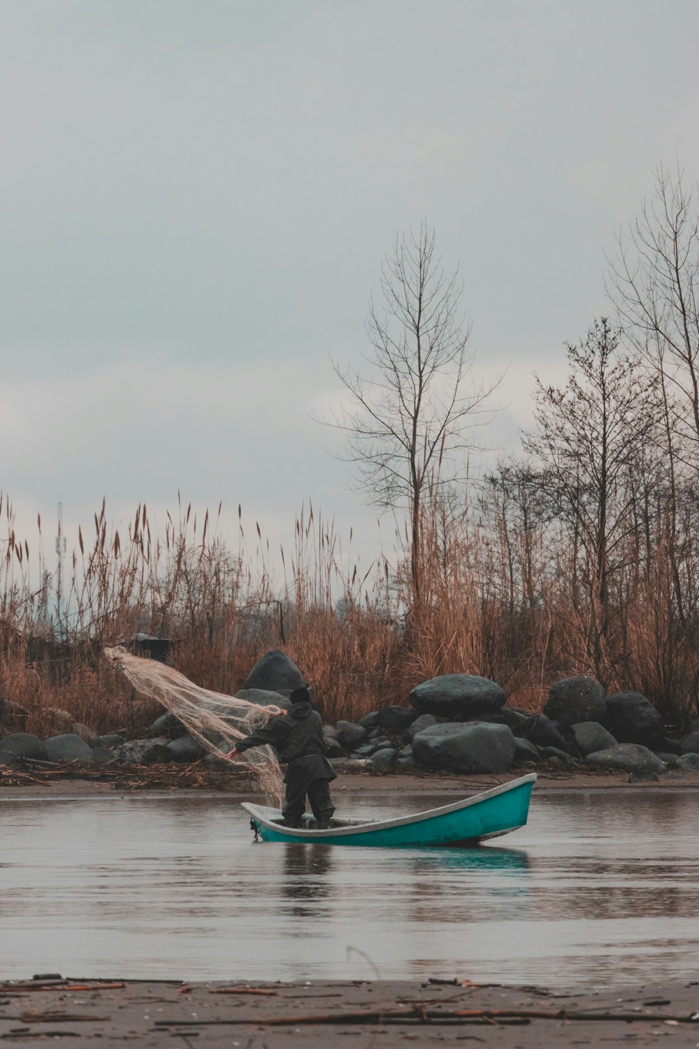 person riding on blue kayak on river during daytime