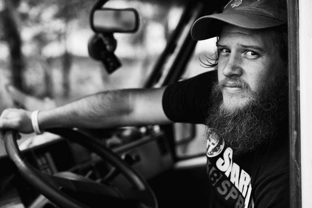 man in black and white crew neck t-shirt wearing black cap