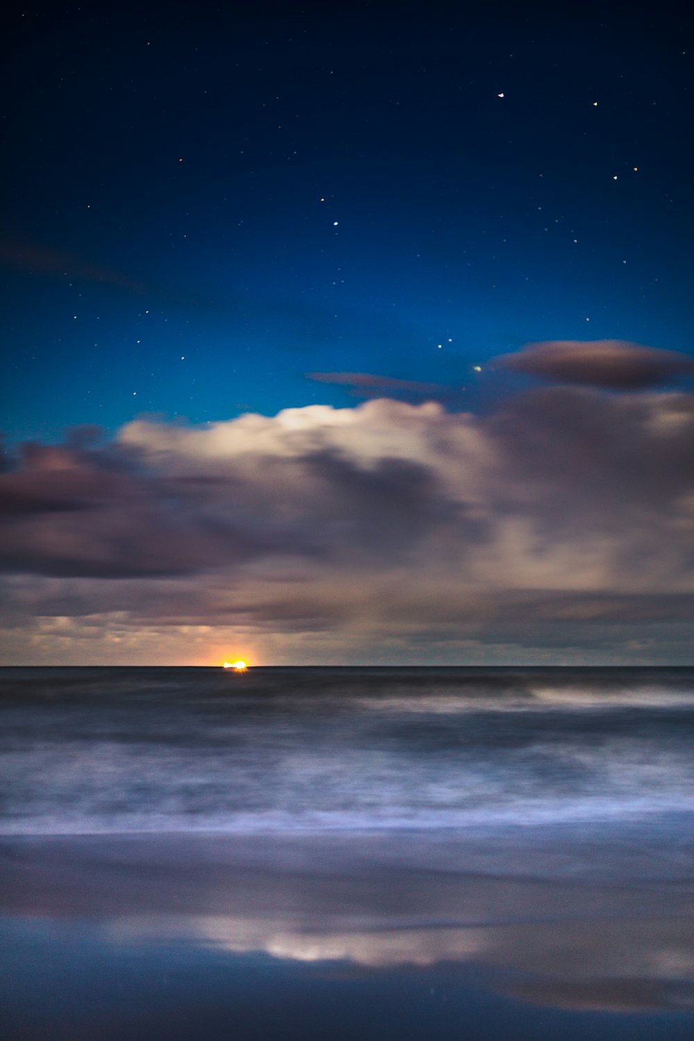 body of water under blue sky during night time