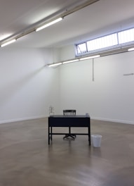 Simple room with a small desk and window letting in natural light