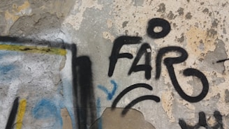 Graffiti on a concrete wall featuring the word 'FARO' in bold black letters. The background shows weathered, peeling paint with hints of yellow, blue, and beige. Various lines and shapes surround the text, adding an abstract element to the street art.